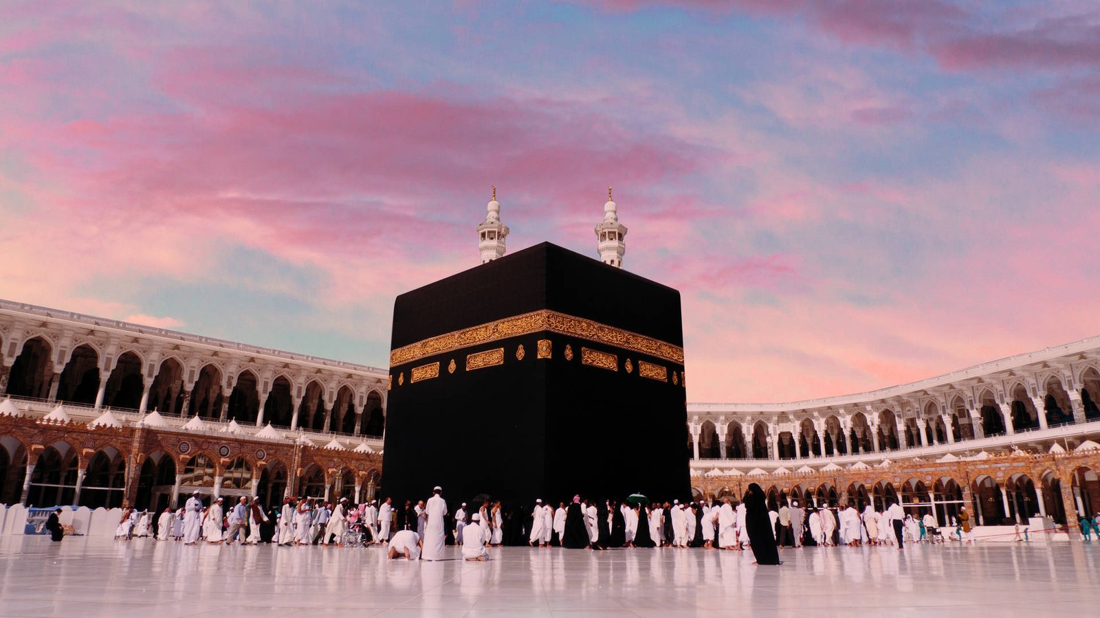 Majestic wide-angle view of the Holy Kaaba in Mecca, casting deep spiritual light and tranquility.